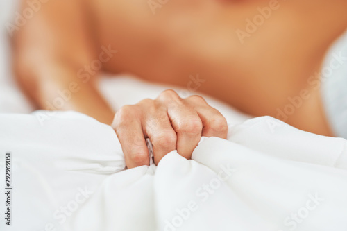 Tableau sur toile Female hand holding bed sheet