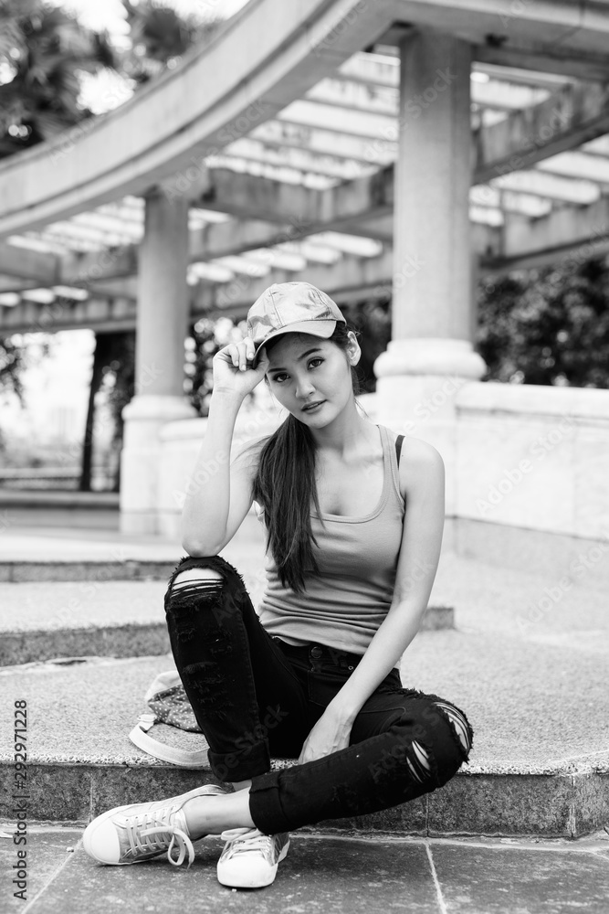 Young beautiful Asian woman relaxing at the park Young beautiful Asian woman relaxing at the park