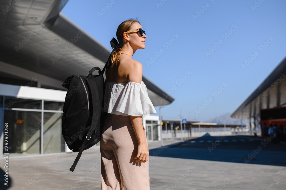 girl tourist with black backpack and sunglasses