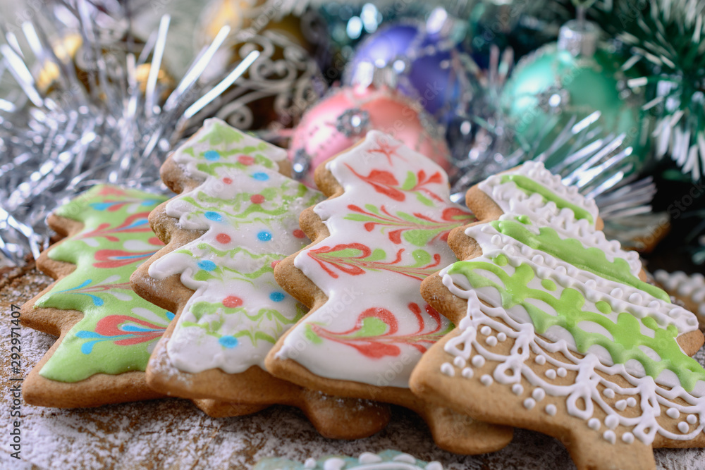 Colorful Christmas gingerbread in the shape of a Christmas trees  decorated with color icing and decorations in a day light