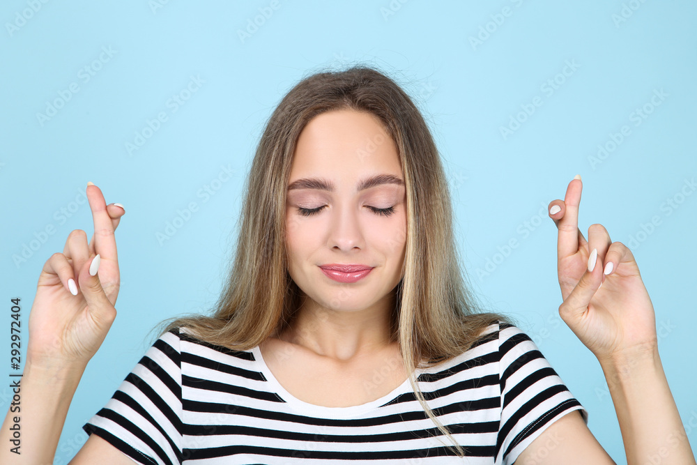 Beautiful young woman on blue background