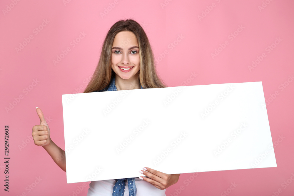 Beautiful young woman holding white blank board and showing thumb up on pink background Beautiful young woman holding white blank board and showing thumb up on pink background