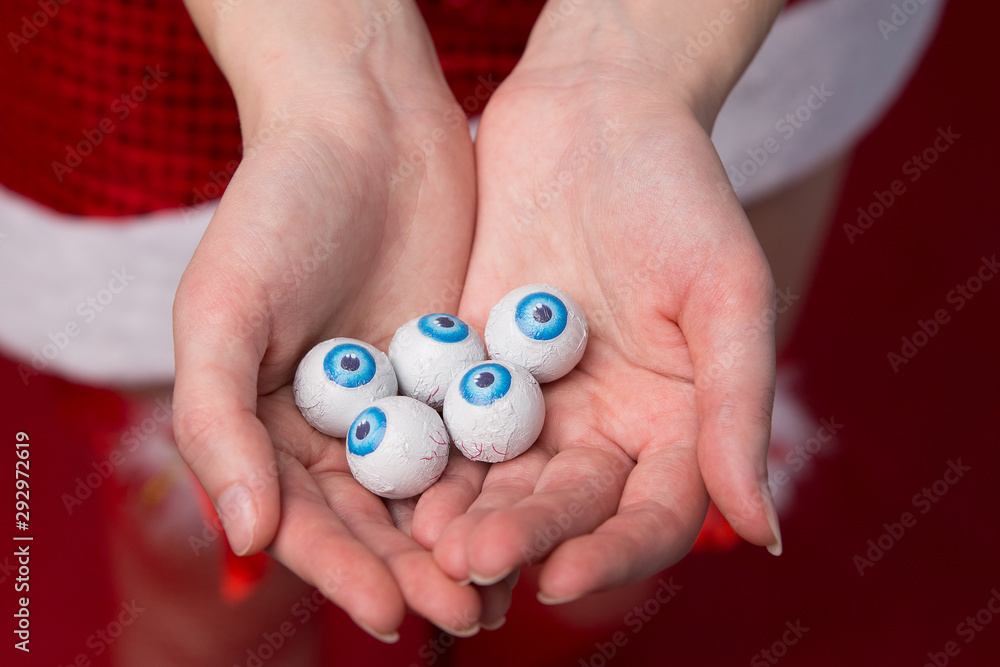 Many eyeballs with blue iris in the palms of the girl. Concept for halloween. Many eyeballs with blue iris in the palms of the girl. Concept for halloween.