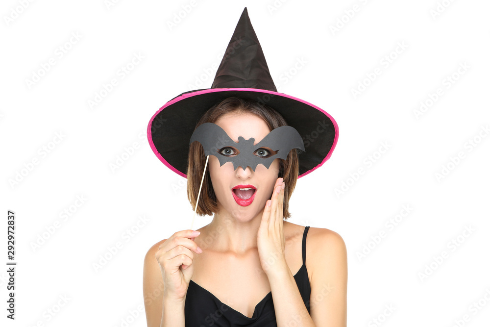 Happy young woman in black halloween costume with paper bat on white background Happy young woman in black halloween costume with paper bat on white background