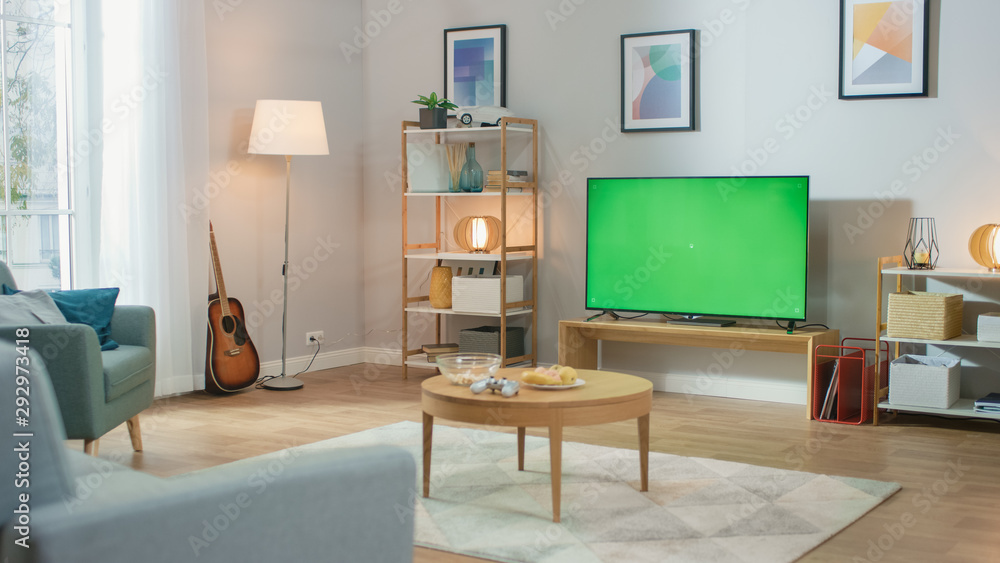 Cozy Living Room with Stylish Furniture and Design, Green Chroma Key TV in the Middle of the Room. Cozy Living Room with Stylish Furniture and Design, Green Chroma Key TV in the Middle of the Room.