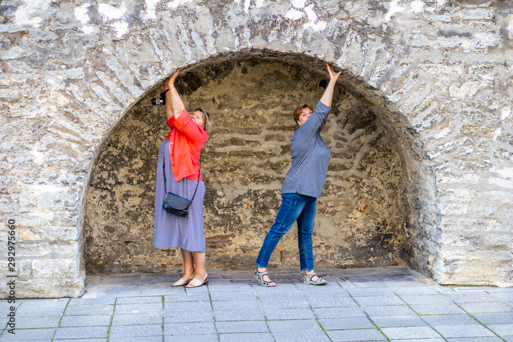 Two Mature women socialize in the old town. Two Mature women socialize in the old town.