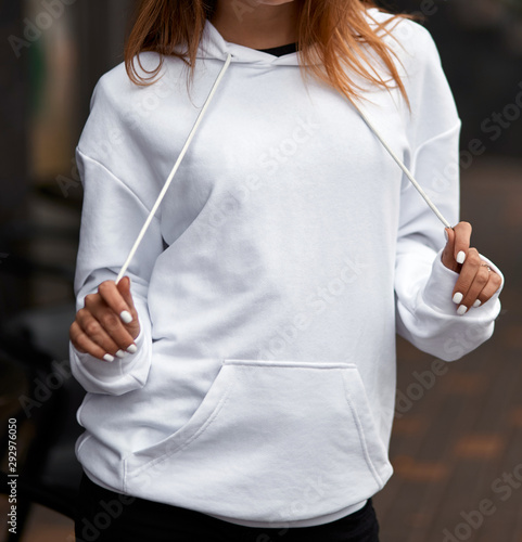 young girl wears white hoodie photo