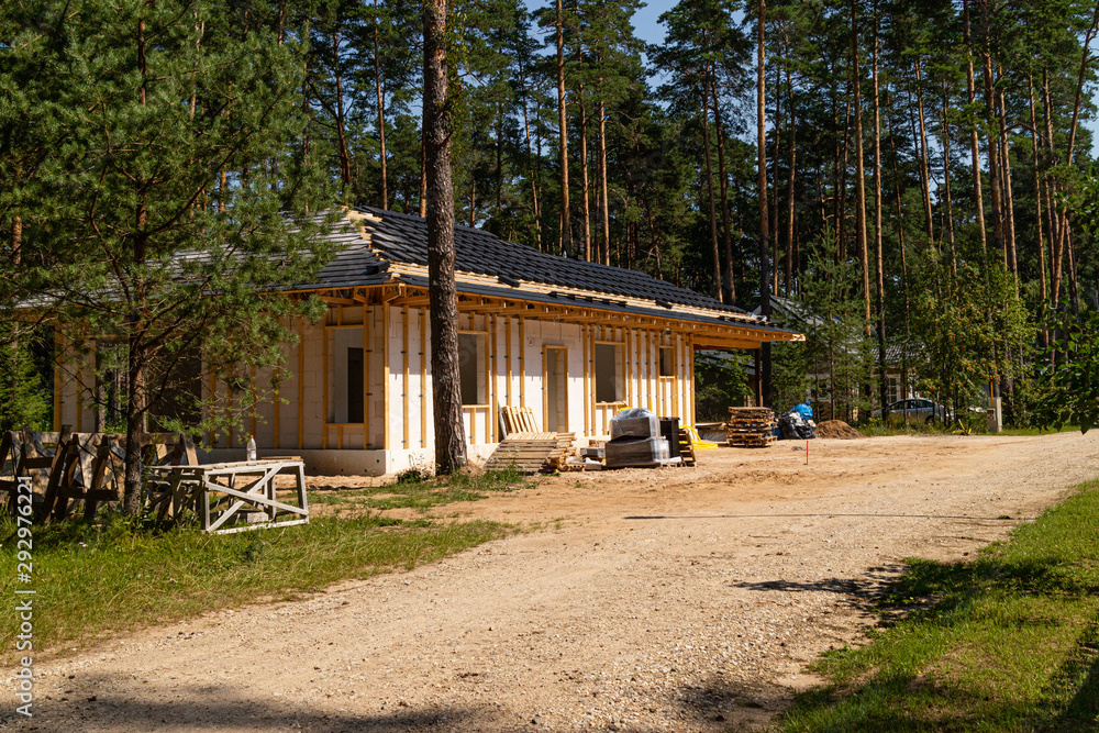 Construction site of a new half built one floor house, cottage on nature Construction site of a new half built one floor house, cottage on nature