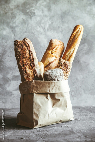 French pastries, baguettes on a gray background in a paper bag.