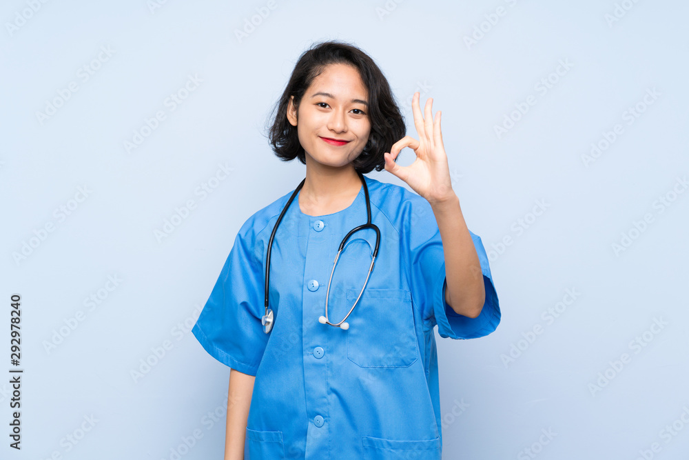 Surgeon doctor woman showing ok sign with fingers Surgeon doctor woman showing ok sign with fingers