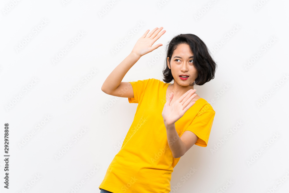 Asian young woman over isolated white background nervous and scared Asian young woman over isolated white background nervous and scared