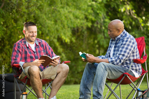 Multi-Ethnic group of friends talking and having a bible study. photo