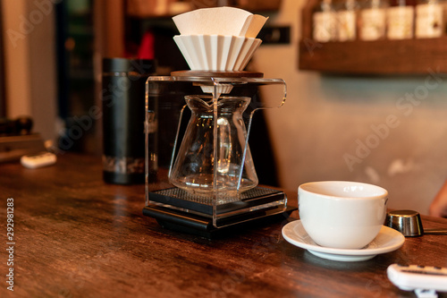 Barista in coffee shop preparing a cappuccino