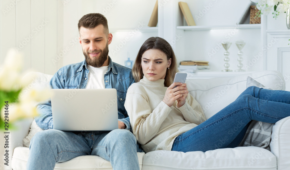 Distrust in relationships. Wife spying at man's laptop Distrust in relationships. Wife spying at man's laptop