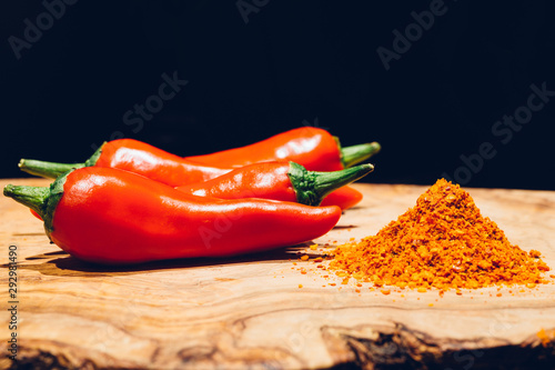 Close up of espelette peppers, fresh and powdered