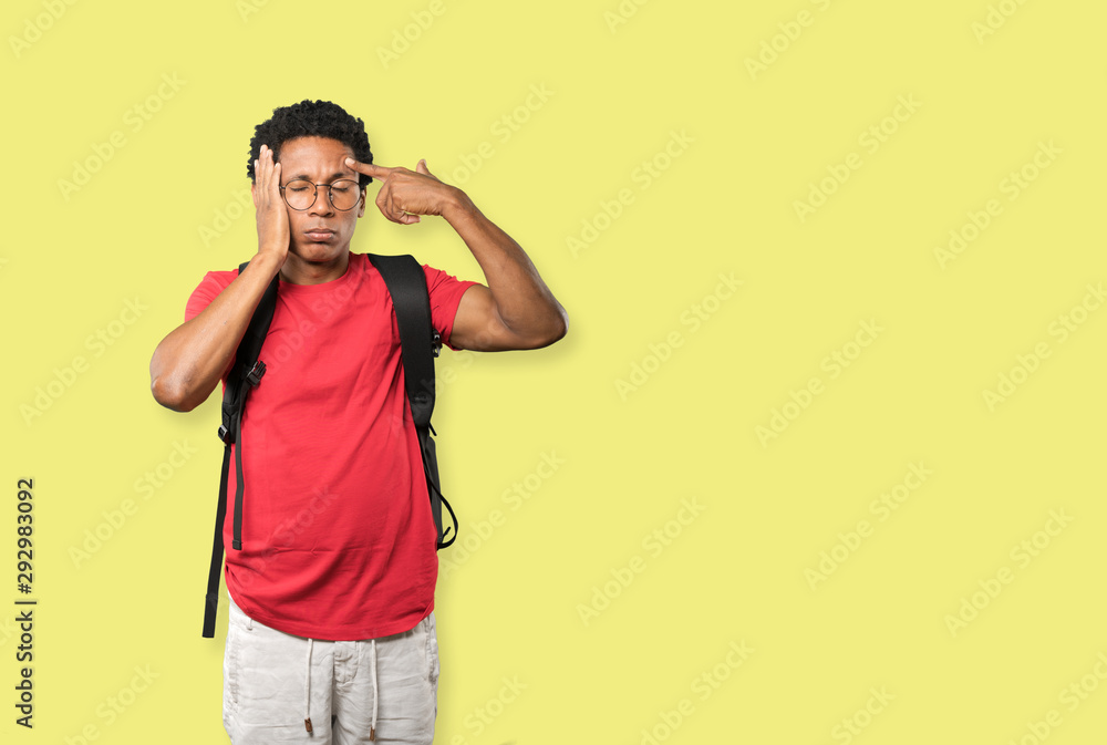 Depressed young man making a suicide gesture Depressed young man making a suicide gesture