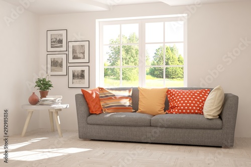 Stylish room in white color with sofa and summer landscape in window. Scandinavian interior design. 3D illustration