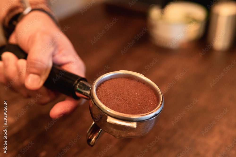 Barista in coffee shop preparing a cappuccino