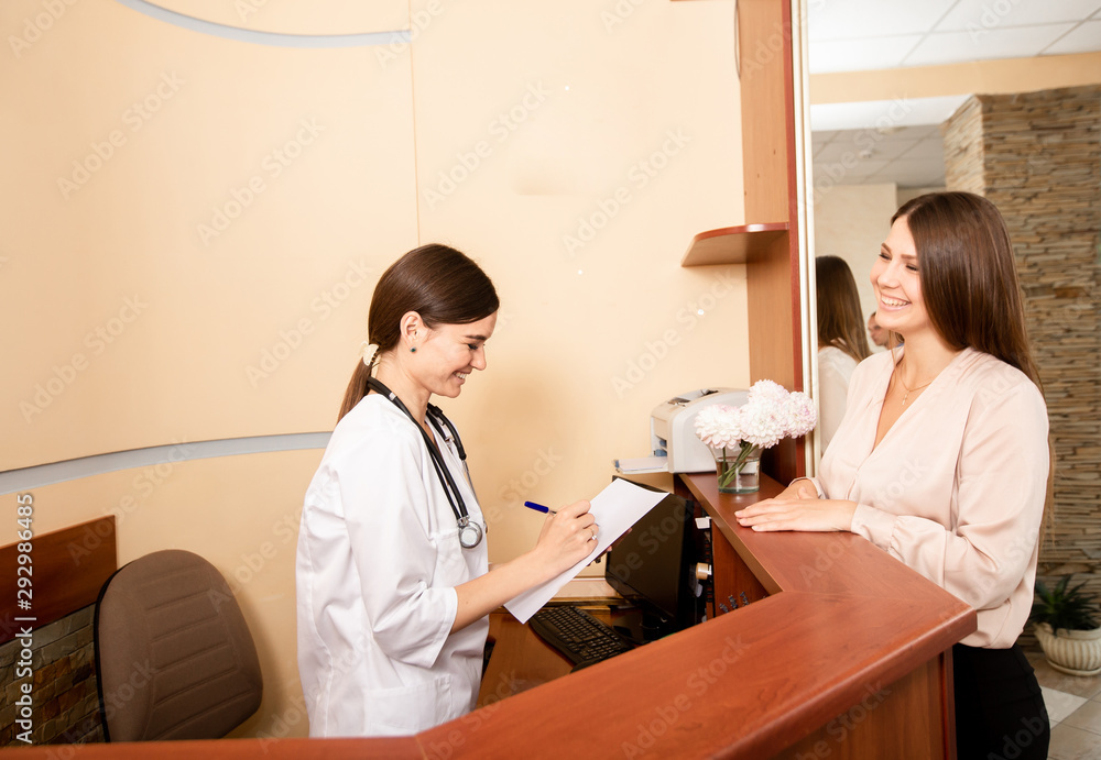 The doctor tells the patient about the types of services and records the girl for an appointment