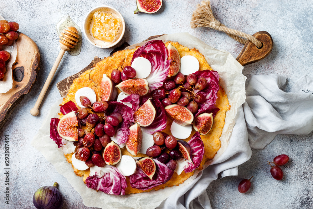 Cauliflower pizza crust with figs, radicchio, goat's cheese and red grapes. Vegetarian, grain free, low carb, gluten free diet concept Cauliflower pizza crust with figs, radicchio, goat's cheese and red grapes. Vegetarian, grain free, low carb, gluten free diet concept