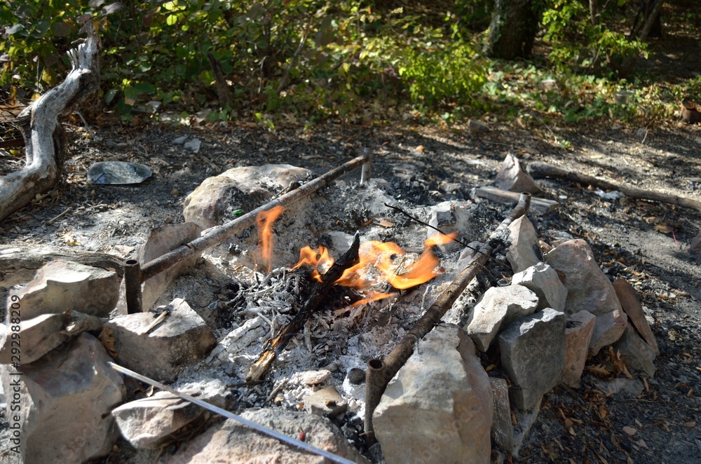 Roasted sausages on a stick over the open campfire. Outdoor food preparation. Roasted sausages on a stick over the open campfire. Outdoor food preparation.
