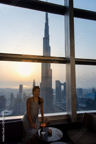Photography Woman enjoying a drink with downtown Dubai view