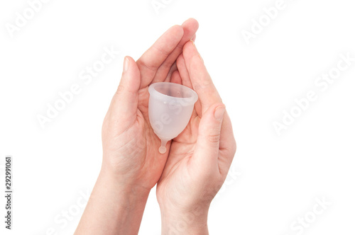 Eco-friendly hypelergenic gynecological silicone menstrual cup for women. Hygienic silicone bowl for collecting menstrual blood in the hands on a white background. Save money.