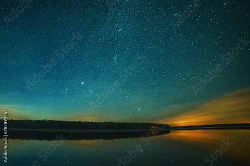 Peaceful starry night sky on the river landscape background Estonia