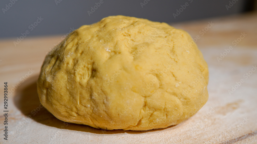 Kneaded yellow dough of eggs and white wheat powder flour. dough for pastry and bread. Dough ingredients concept Kneaded yellow dough of eggs and white wheat powder flour. dough for pastry and bread. Dough ingredients concept