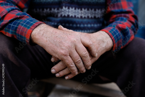 Pair of old hands clasped together. Aging process. Wrinkled hands of old man.