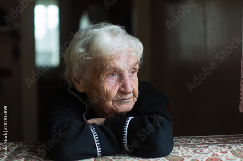 Portrait of a lonely sceptical old woman in his home.