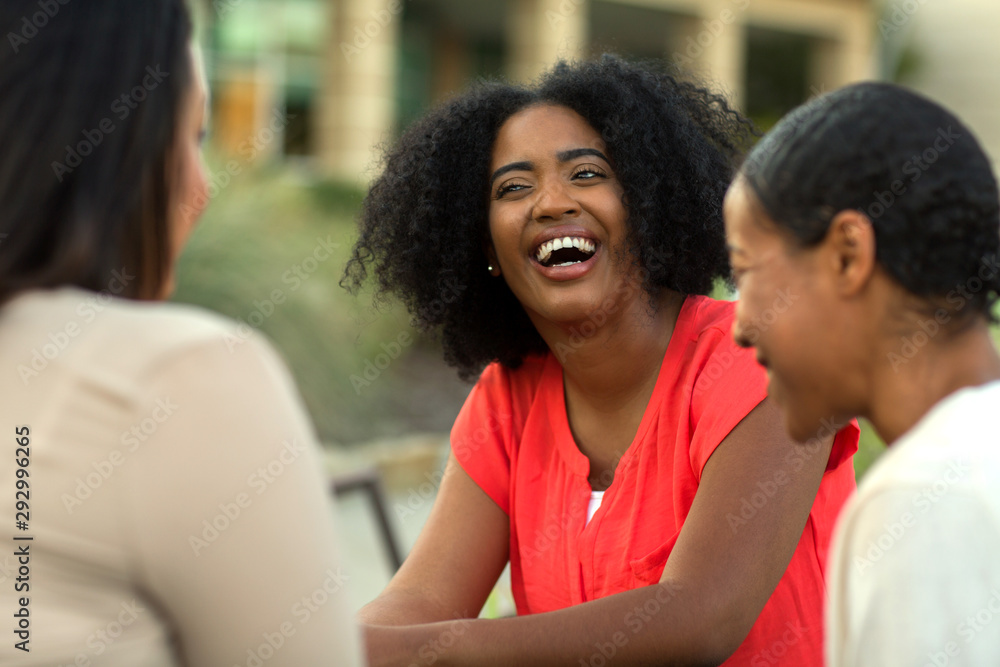 Diverse group of friends talking and laughing. Diverse group of friends talking and laughing.