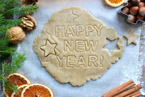 Christmas pastries. Homemade cakes or cookies for the new year and Christmas. Text happy new year. Spices, nuts, dried oranges, spruce branches. New year, Christmas background.