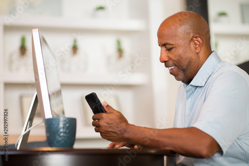 Mature African American man working from his home office. photo