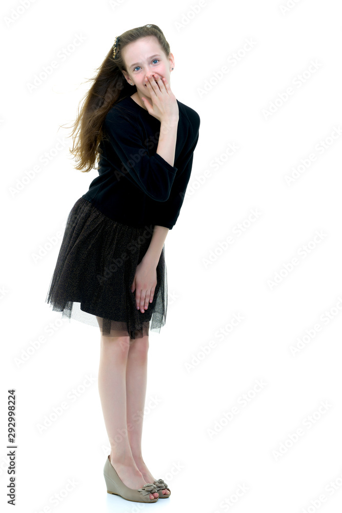 A beautiful little girl stands in the wind, her hair and clothes A beautiful little girl stands in the wind, her hair and clothes