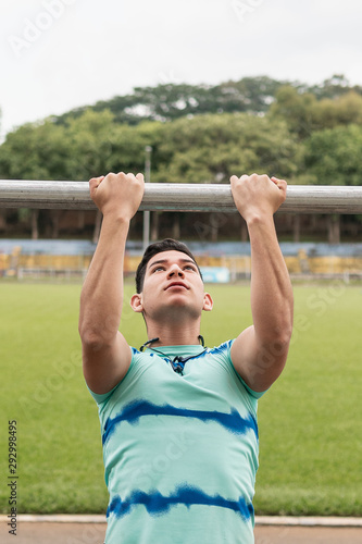 Young man doing sports and warm up exercises