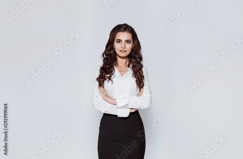 Portrait of young modern business woman in classic suit. Attractive female business leader in smart casual wear with crossed arms. Office worker.