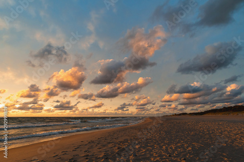 Sun sunset on autumn beach dramatic sky on background