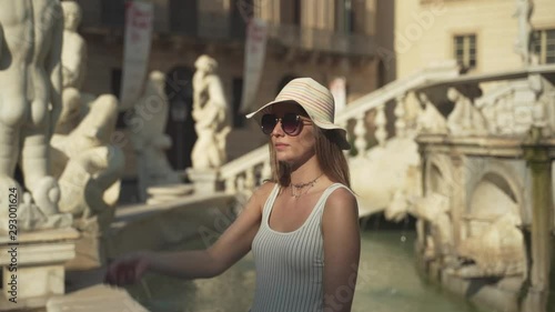 Dreamer girl throws the coin in the fountain for her dream