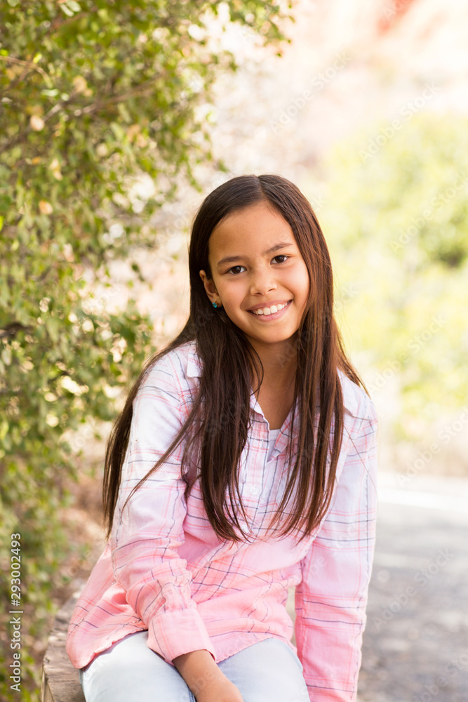 Portrait of a young asian girl smiling outside. Portrait of a young asian girl smiling outside.