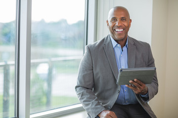 Mature African American man working on a tablet.