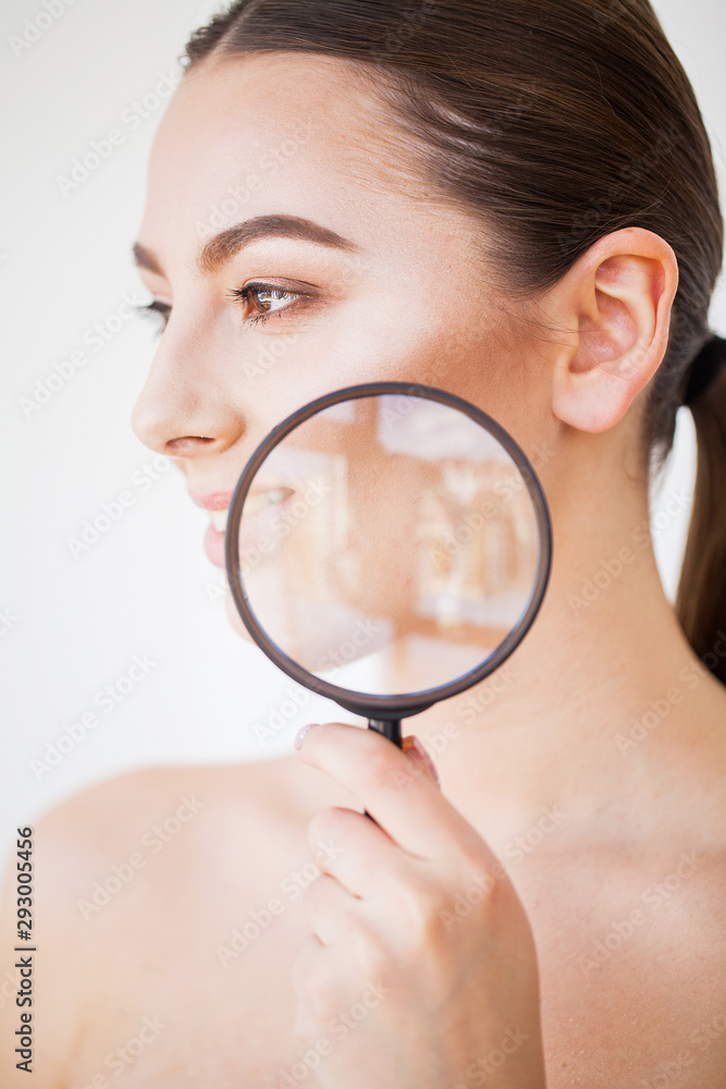 Woman Looking Through Magnifier And Smiling Close Up Woman Looking Through Magnifier And Smiling Close Up