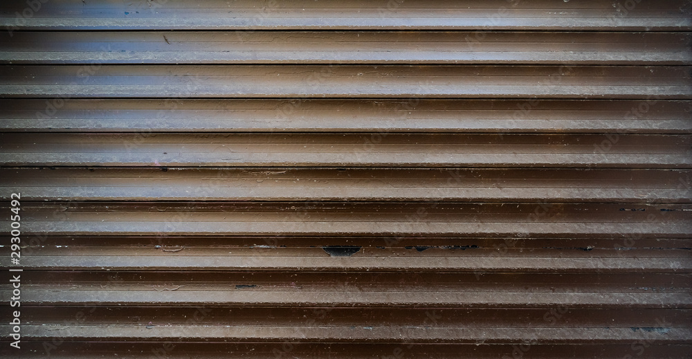 Dark worn out texture of closed metal shutters Dark worn out texture of closed metal shutters