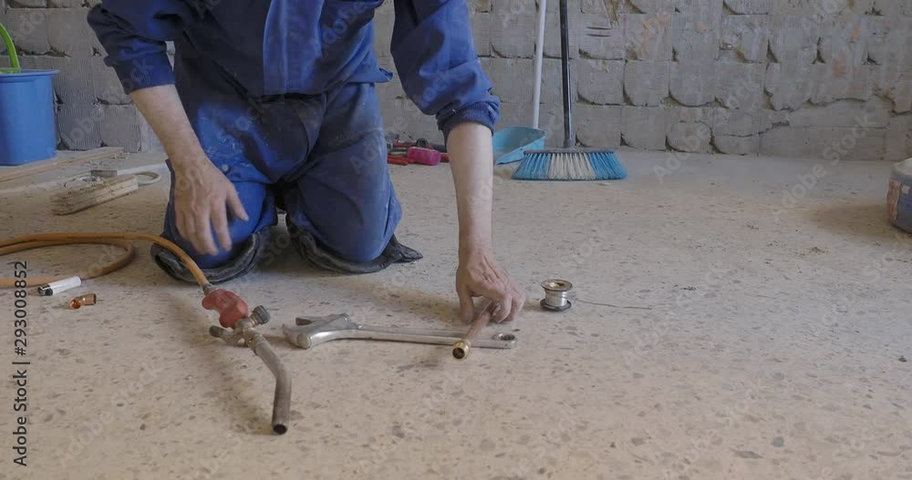 Plumber heating a copper tube with a torch to be able to weld it with tin. Plumber heating a copper tube with a torch to be able to weld it with tin.