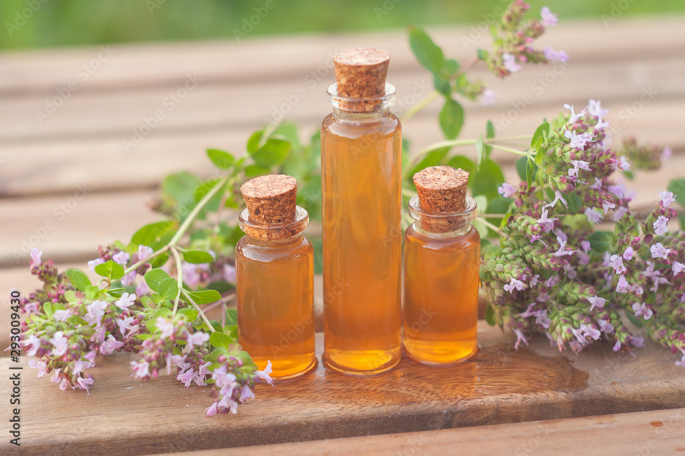 Essence of lavender flowers on table in beautiful glass Bottle Essence of lavender flowers on table in beautiful glass Bottle