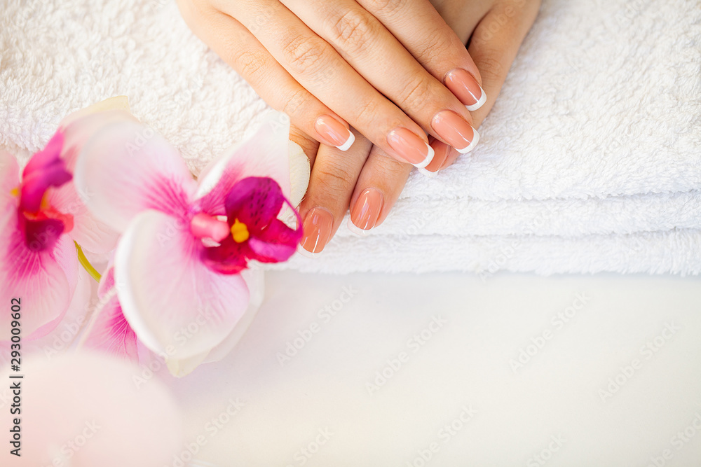 Beautiful woman's nails with french manicure, in beauty studio Beautiful woman's nails with french manicure, in beauty studio
