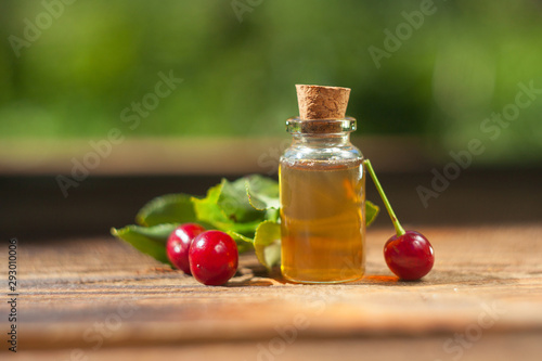 Essence of cherry on table in beautiful glass Bottle