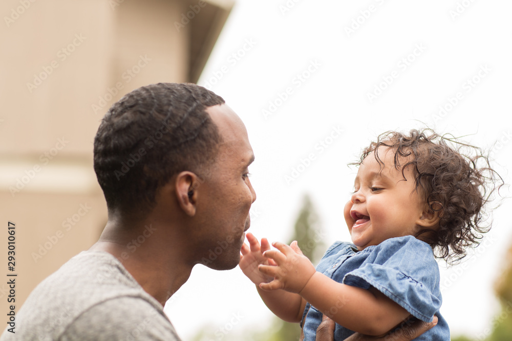 Father holding his little girl. Mixed race family. Father holding his little girl. Mixed race family.