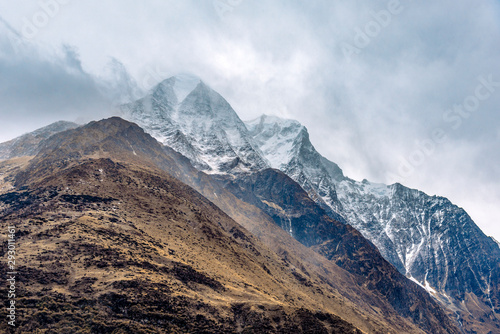 Beautiful Himalaya mountains covered with snow and wrapped in fog, Manaslu Circuit Trek.