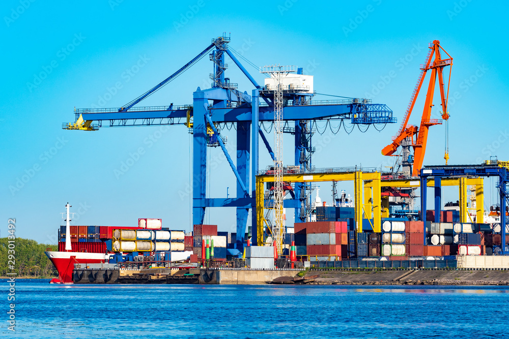 Unloading a freight ship. Cargo ferries. Cargo port. The process of unloading containers. Sea containers. Sea containers on a freight ship. Cargo transportation by sea. Freight ship at the harbor.